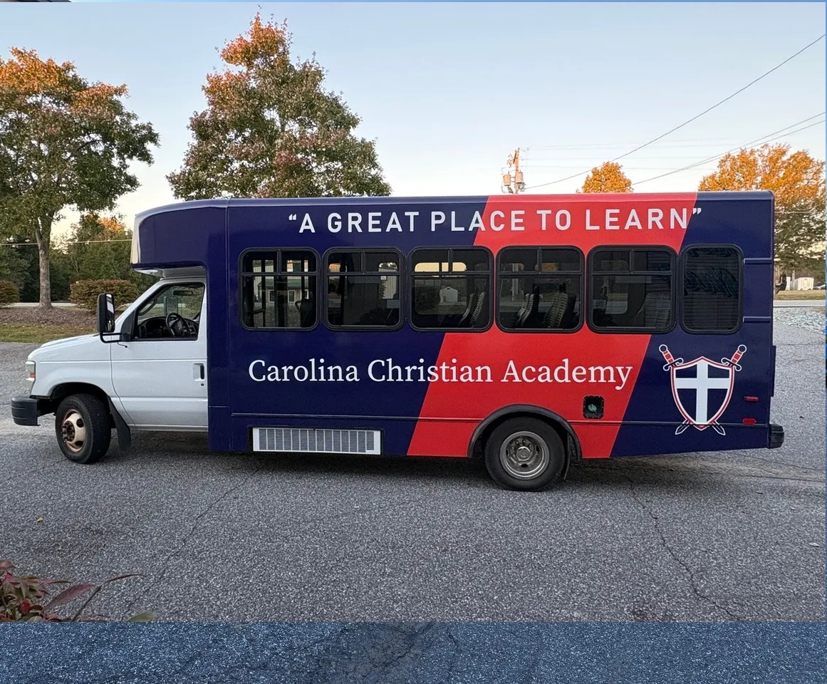 Carolina Christian Academy activity bus with a custom full-color bus wrap