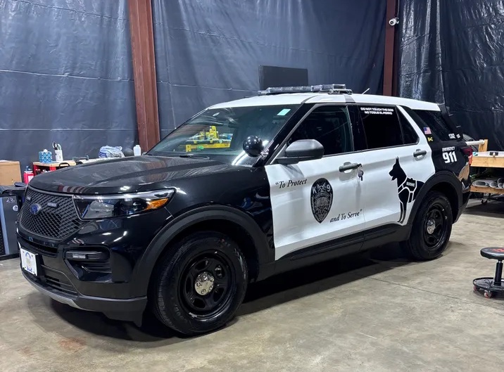 Black-and-white law enforcement SUV with reflective vinyl decals and graphics